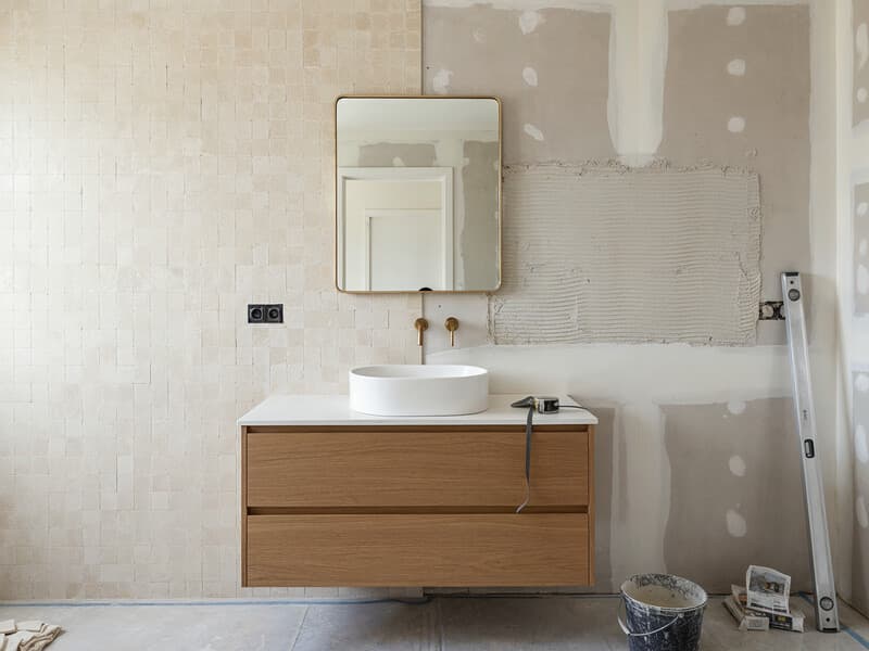 Calm renovation site with finished materials, plans, and precise installation details.